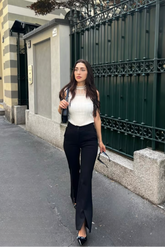 a lady in a white lace patchwork tank top and a pair of black micro-flared slit pants